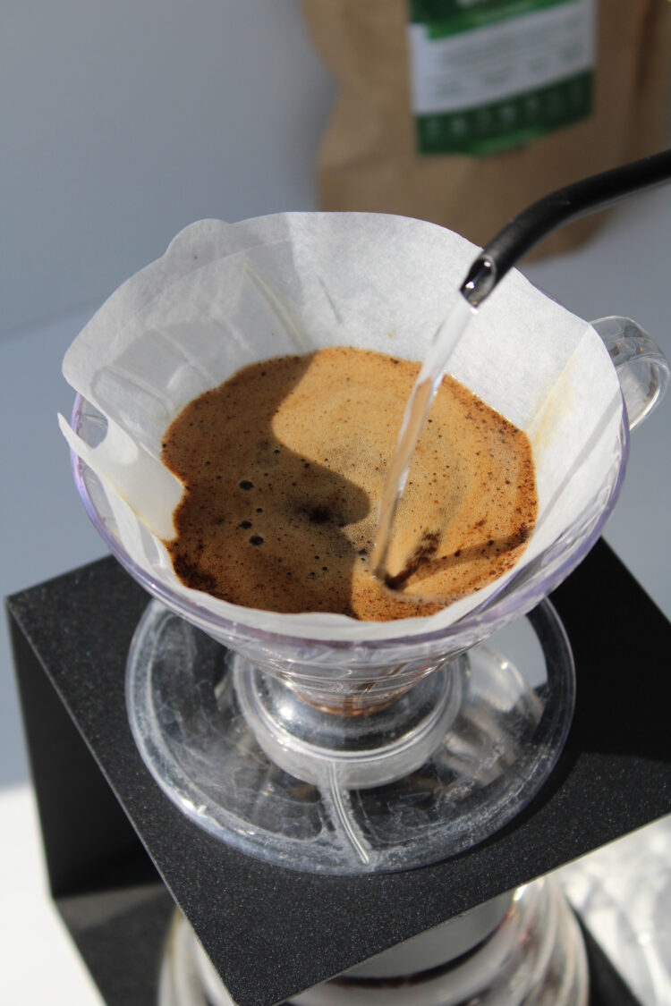 Person brewing coffee using V60 pour over technique